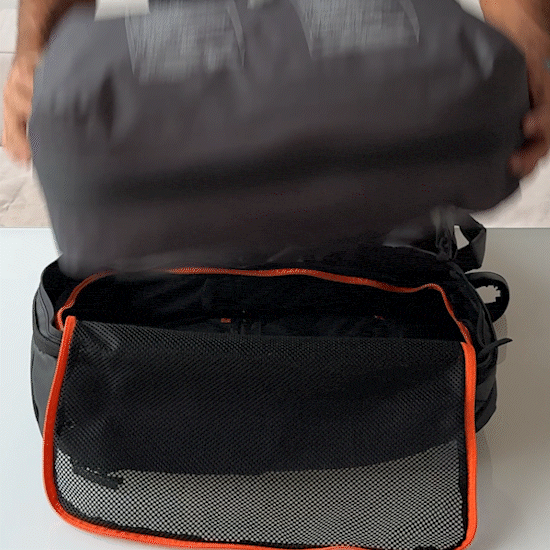 Person places the Vacuum Bag 2.0 into the Jaimie Jacobs backpack.